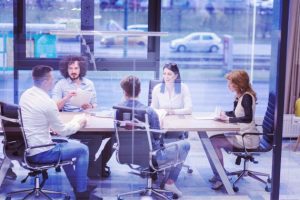 Team members from Primo Umbrella engaged in a strategic business meeting in a modern conference room.